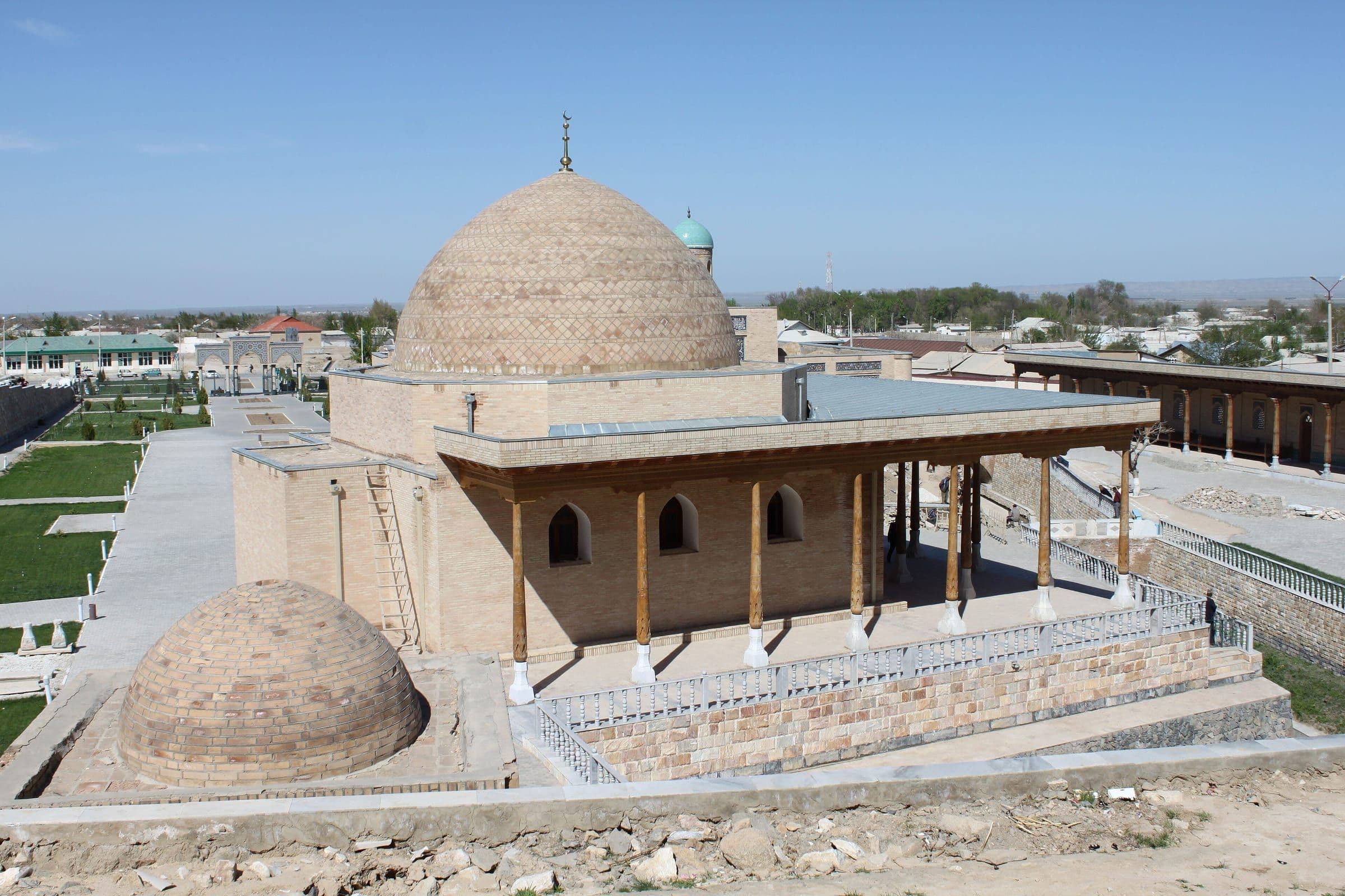 Mosque of the Chashma complex in Nurata, with a great patterned brick dome and a porch on tall wooden columns